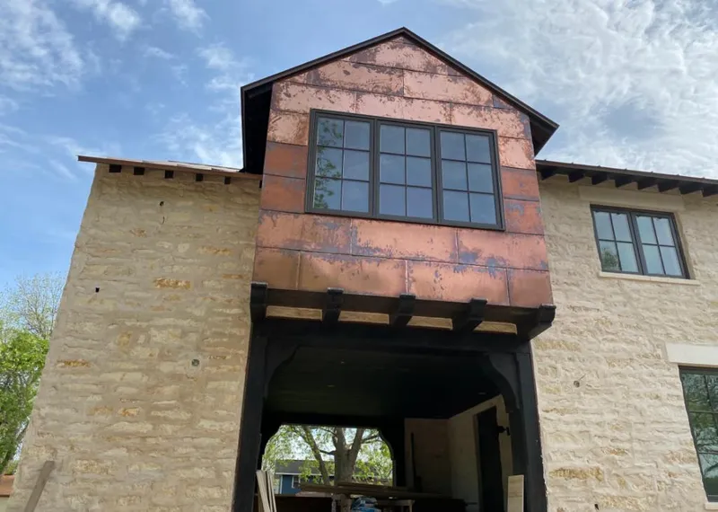Copper metal panel facade on a stone building for Metal Roof Coating in Dakota Dunes