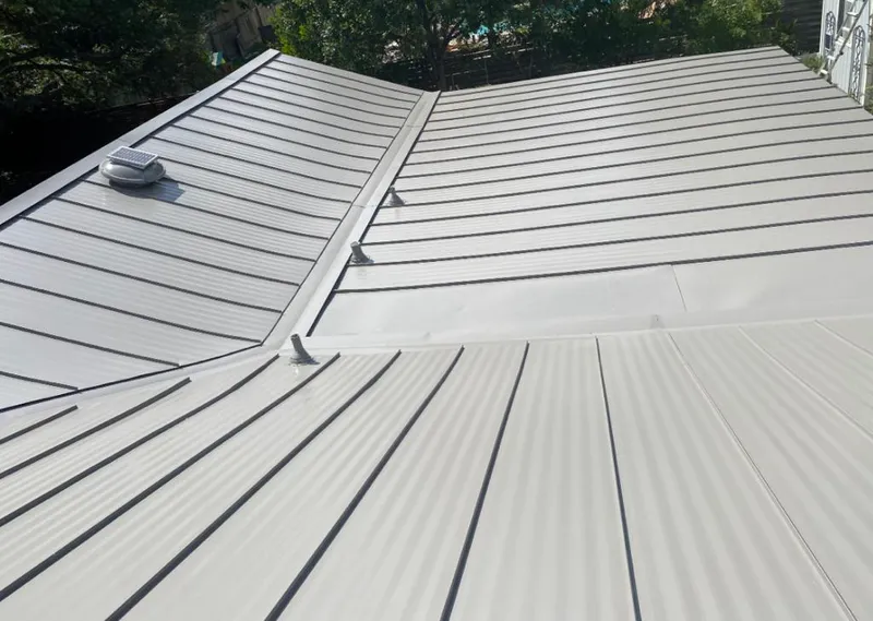 Solar attic fan installed on a metal roof for Roof Ventilation in Dakota Dunes